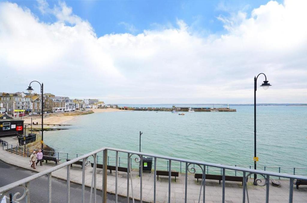 a view of a beach with a pier in the water at 1 Bed in St. Ives oc-pc716a in St Ives