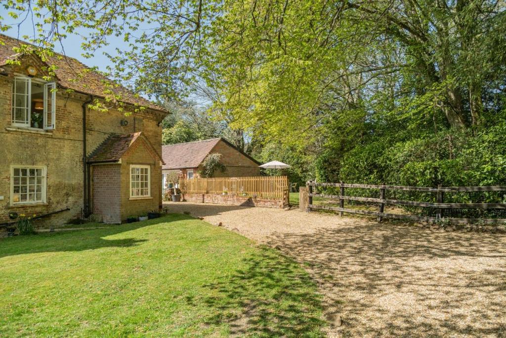 an old brick house with a fence and a yard at 2 Bed in Landford oc-l31877 in Landford