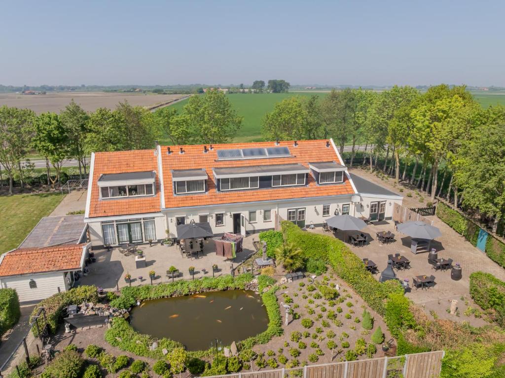 an aerial view of a house with a garden at B&B Plompetorenzicht in Burgh Haamstede