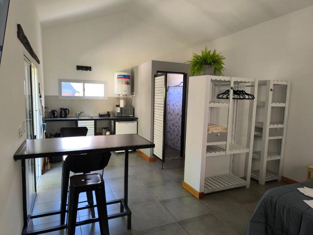 a kitchen with a table and chairs in a room at AlojaMenta in Nono