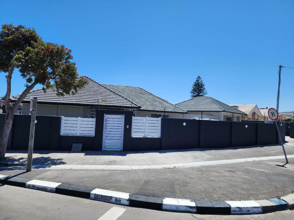 a building with white doors and a fence at Wagenaar Villas in Monte Vista