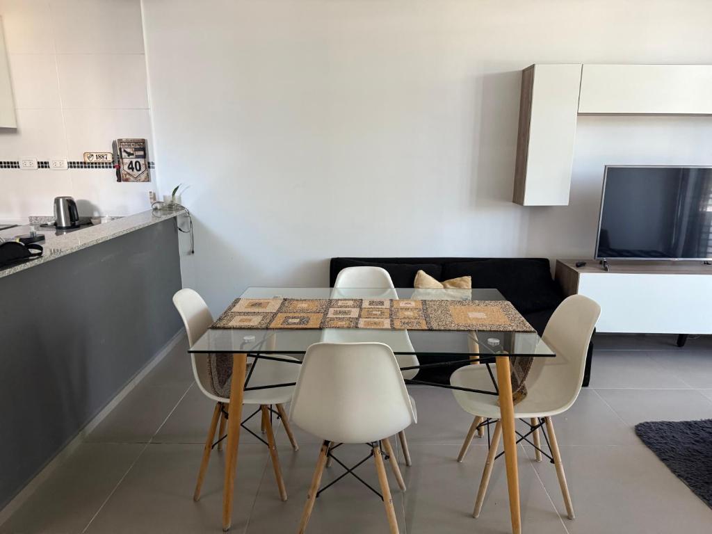 a dining room with a table and some chairs at Iluminado y céntrico in San Nicolás de los Arroyos