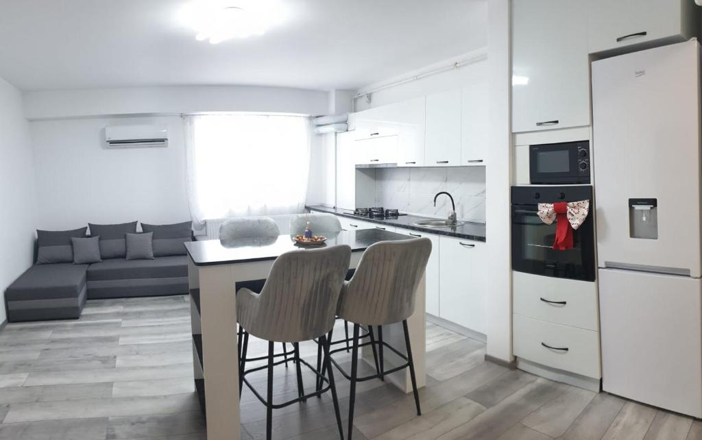 a kitchen with a table and two chairs in a room at Apartament in Craiova
