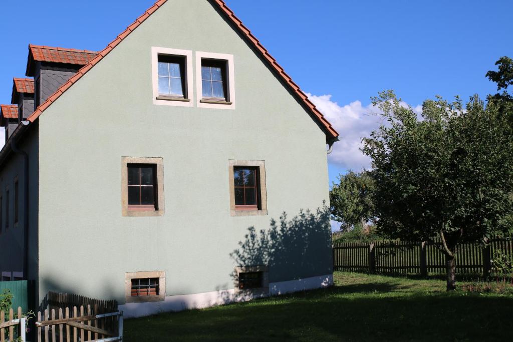 a white house with a red roof at Ferienwohnung am Stadtrand in Dresden