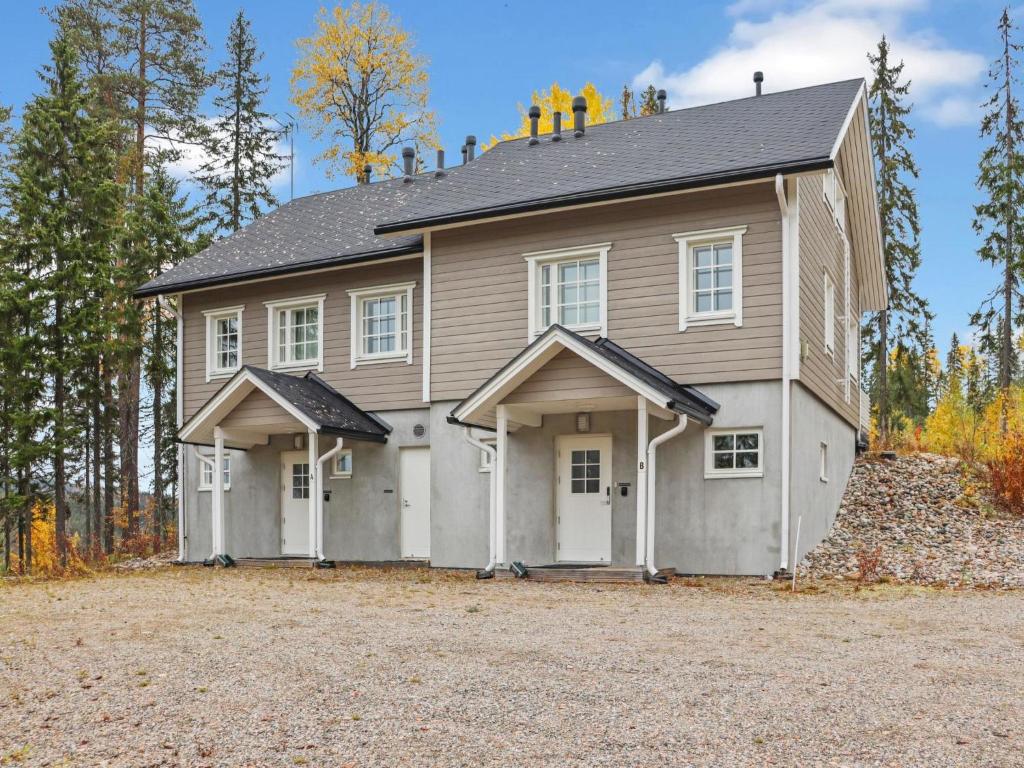 a large house with a garage on a driveway at Holiday Home Pikkuhukka by Interhome in Hyrynsalmi