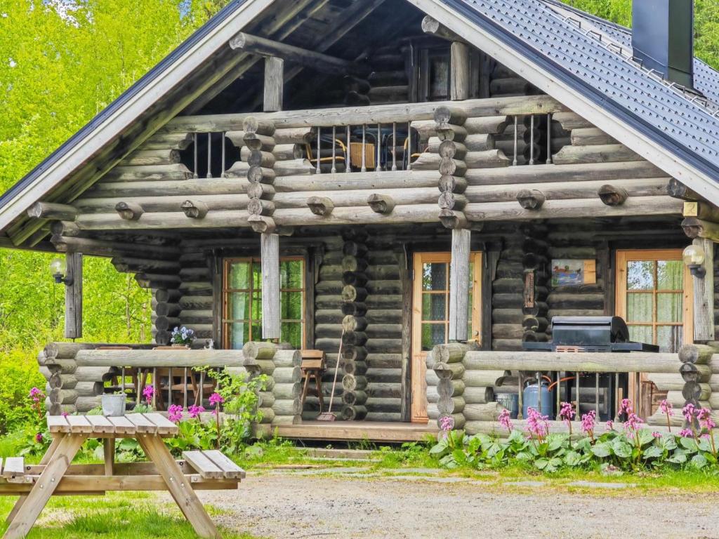 a log cabin with a bench in front of it at Holiday Home Heinäsorsa by Interhome in Rutalahti