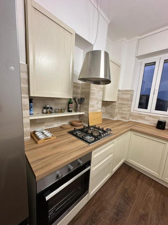 a kitchen with white cabinets and a stove top oven at Casa Giovanni in Turin
