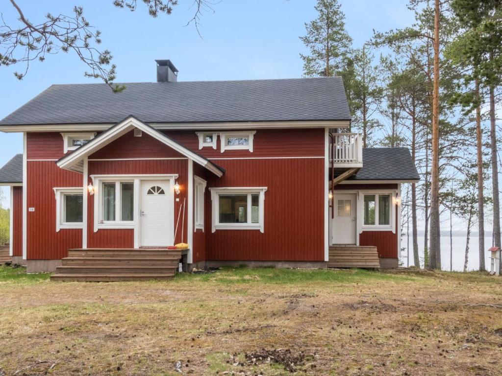 a red house with a white door at Holiday Home Rantala by Interhome in Ranua