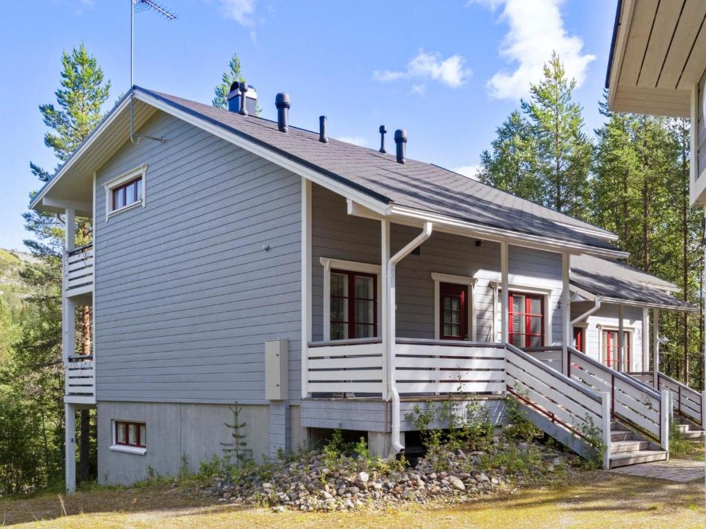 a house with a gambrel roof with a porch at Holiday Home Kelkka 2 by Interhome in Salla