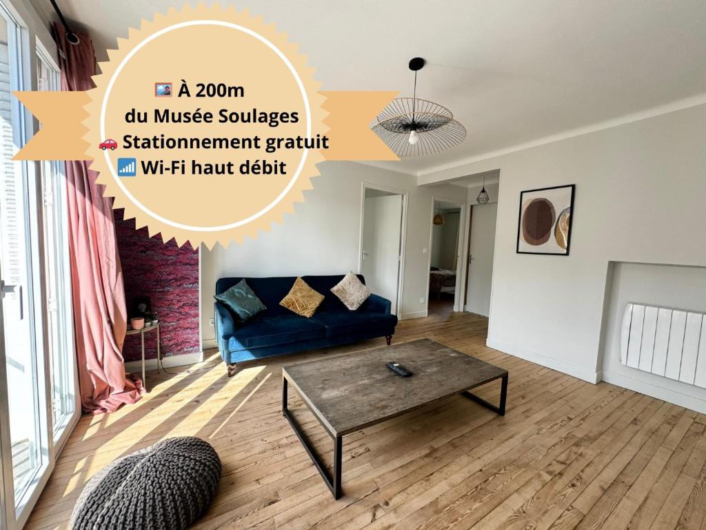 a living room with a couch and a coffee table at Le 122 - Parking in Rodez