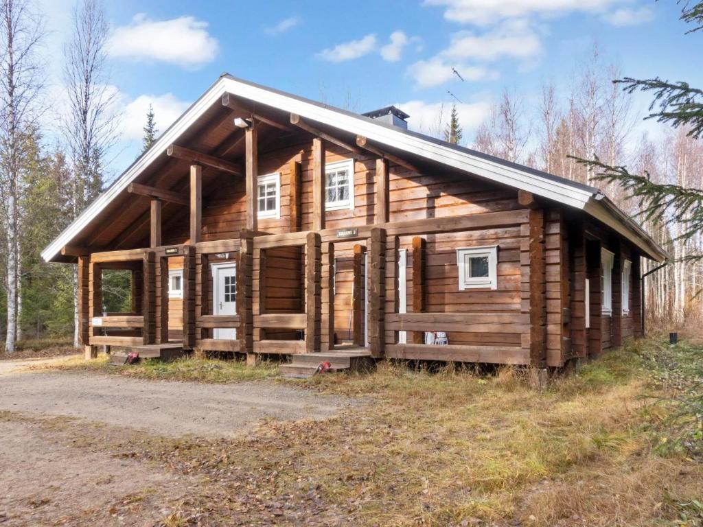 a log cabin with a gambrel roof at Holiday Home Kranni 2 by Interhome in Syöte