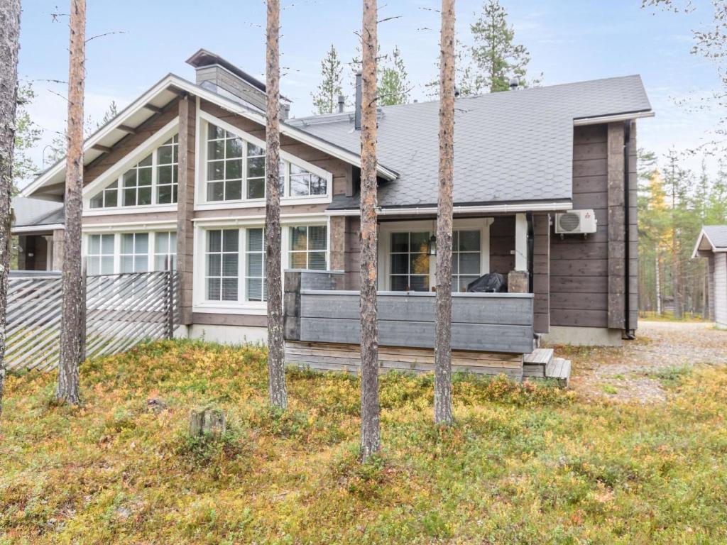 a house with trees in front of it at Holiday Home Otsonherra by Interhome in Pyhätunturi