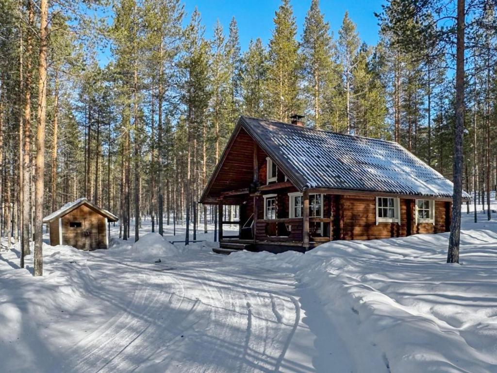 a log cabin in the woods in the snow at Holiday Home Lumomarja by Interhome in Pyhätunturi