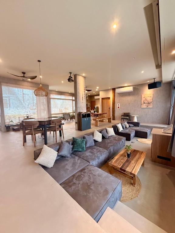 a large living room with a couch and a table at Zenith Retreat in Xiaoliuqiu