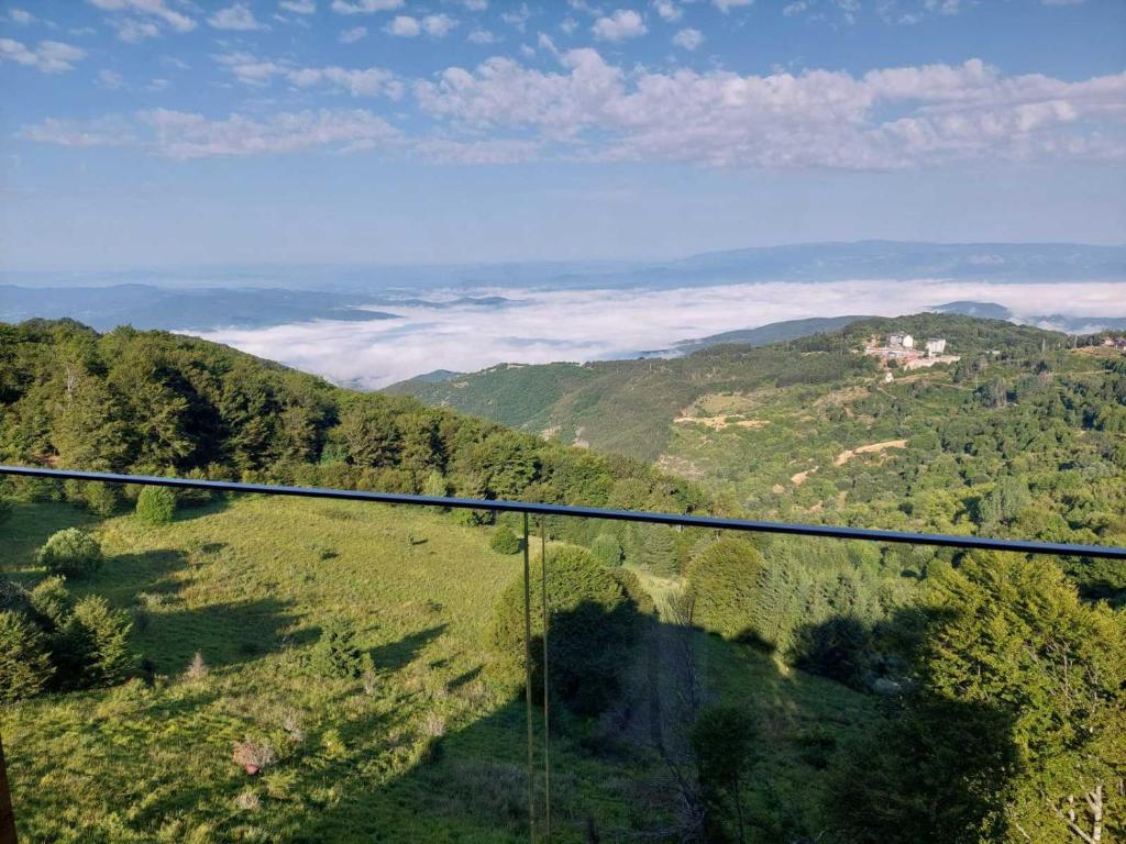 a view of a valley with trees and mountains at Sky Nest Kopaonik in Kopaonik