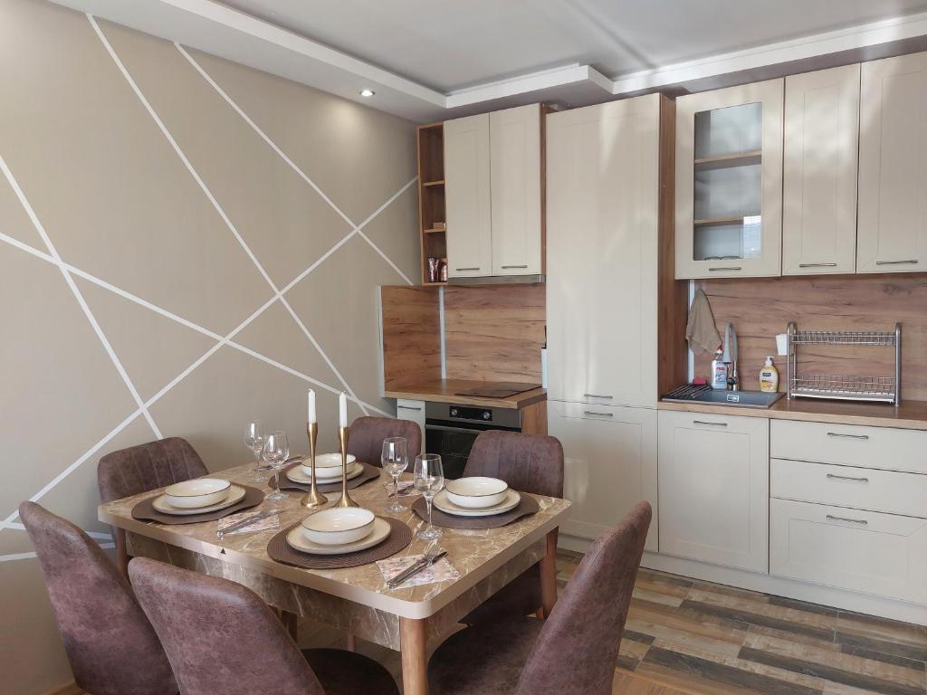 a dining room with a wooden table and chairs at Strumsko Stay in Blagoevgrad