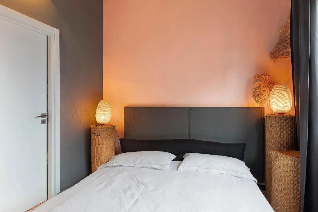 a bedroom with a bed with two lamps on it at Mistral Holidays - Minisuite con Terrazzino in Marina di Carrara