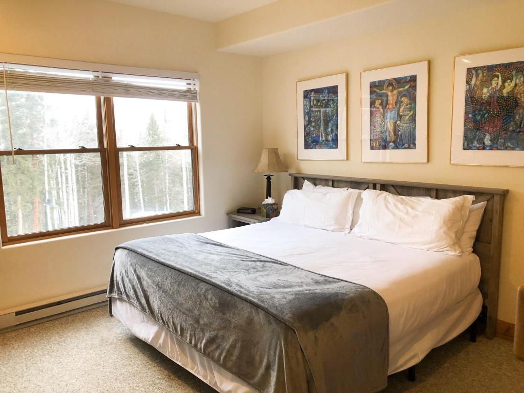 a bedroom with a large bed and two windows at Bear Creek Lodge 209C in Telluride