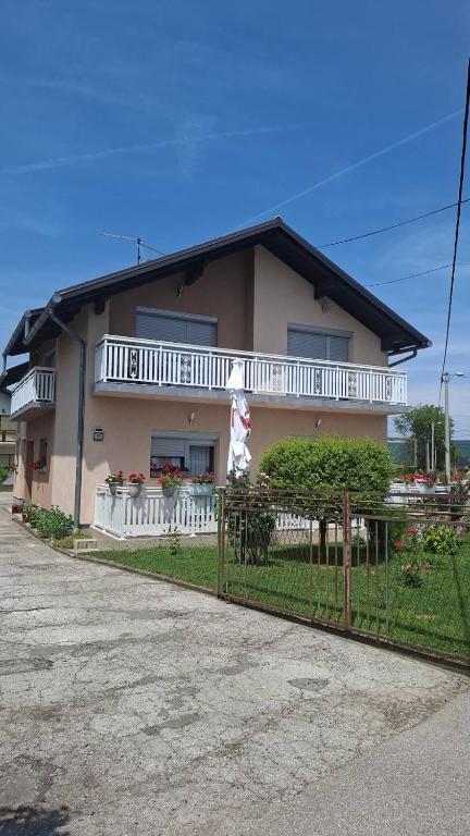 a house with a fence in front of it at Apartman - TAHRIC in Bihać