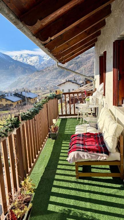 a balcony with a bed and a view of the mountains at Maison Jacquemin in Saint-Pierre