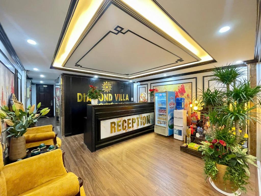 a store with a yellow couch and flowers in a room at Diamond Hotel CoLinh in Long Biên