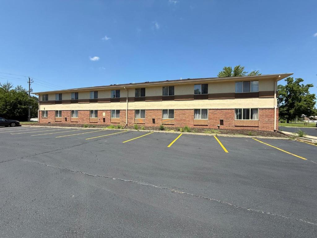 an empty parking lot in front of a building at Fairview Inn & Suites Whitewater in Whitewater