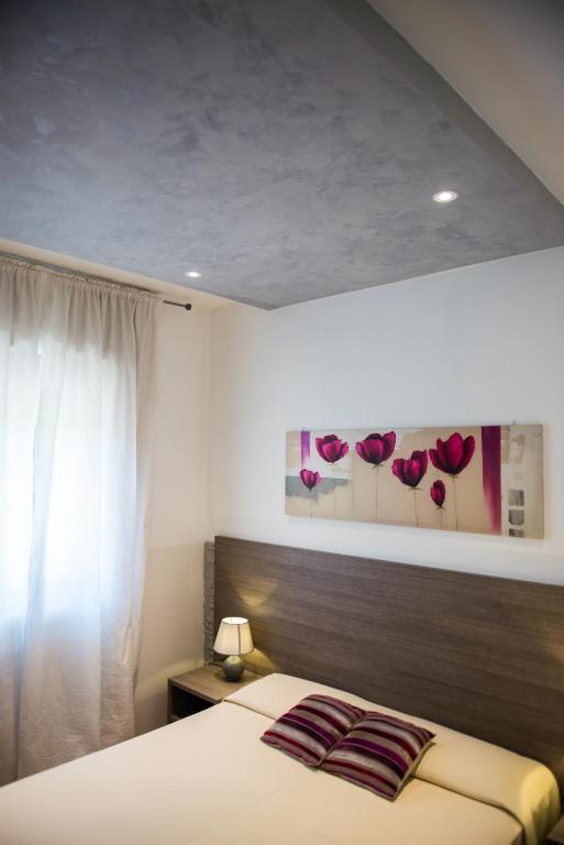 Postel nebo postele na pokoji v ubytování Albergo Grappolo D'oro