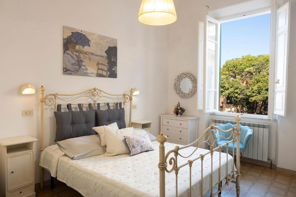a bedroom with a white bed and a window at Hotel Torre in Viareggio
