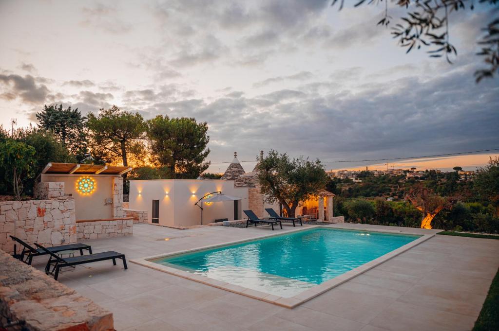 a swimming pool in the backyard of a house at Trullo Alisia - TrulloExperience in Putignano