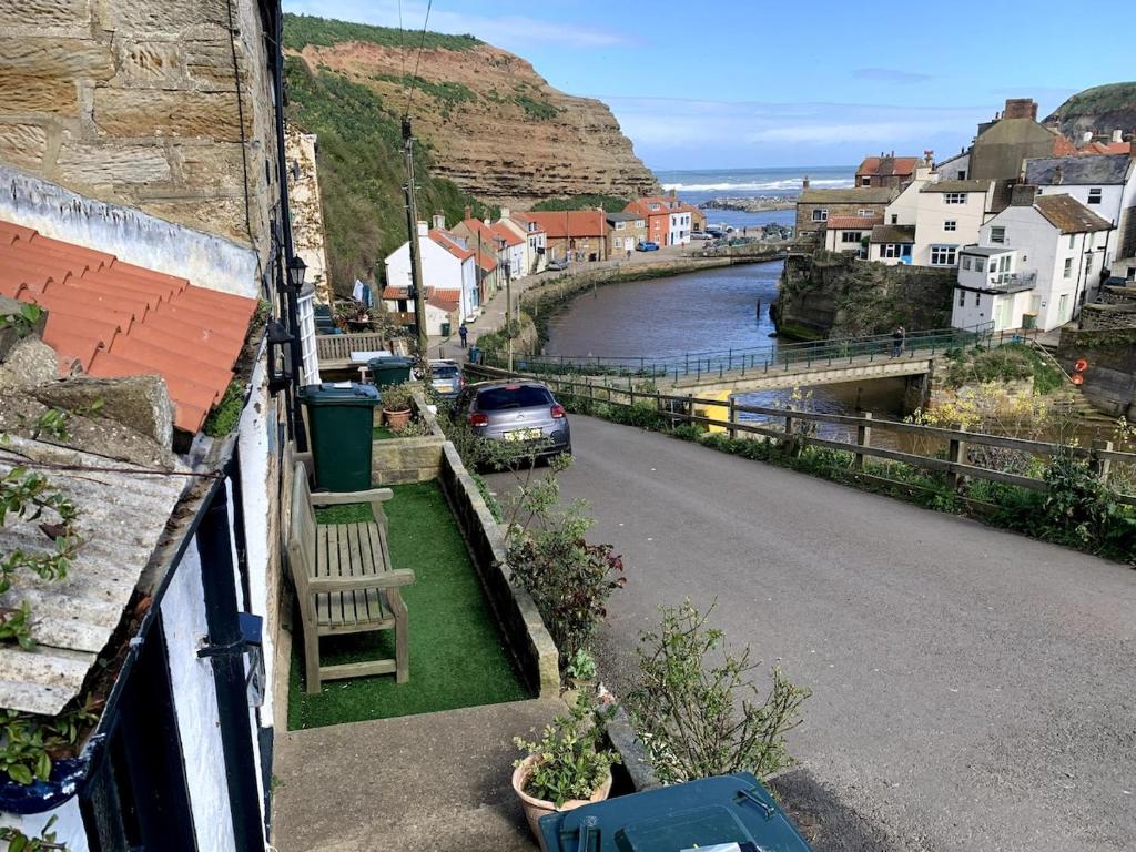 a view of a town with a car driving down a street at Fisherman's Cottage, Staithes in Staithes