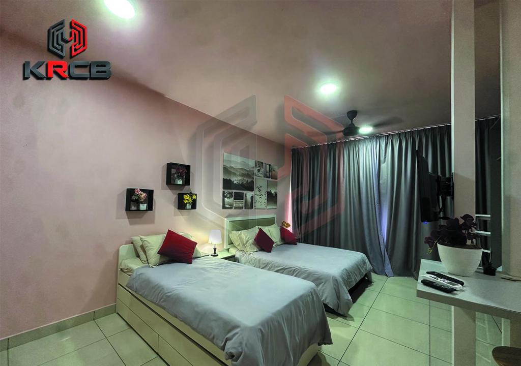 a hotel room with two beds and a desk at KRCB Suite Evo Mall Bangi in Bangi
