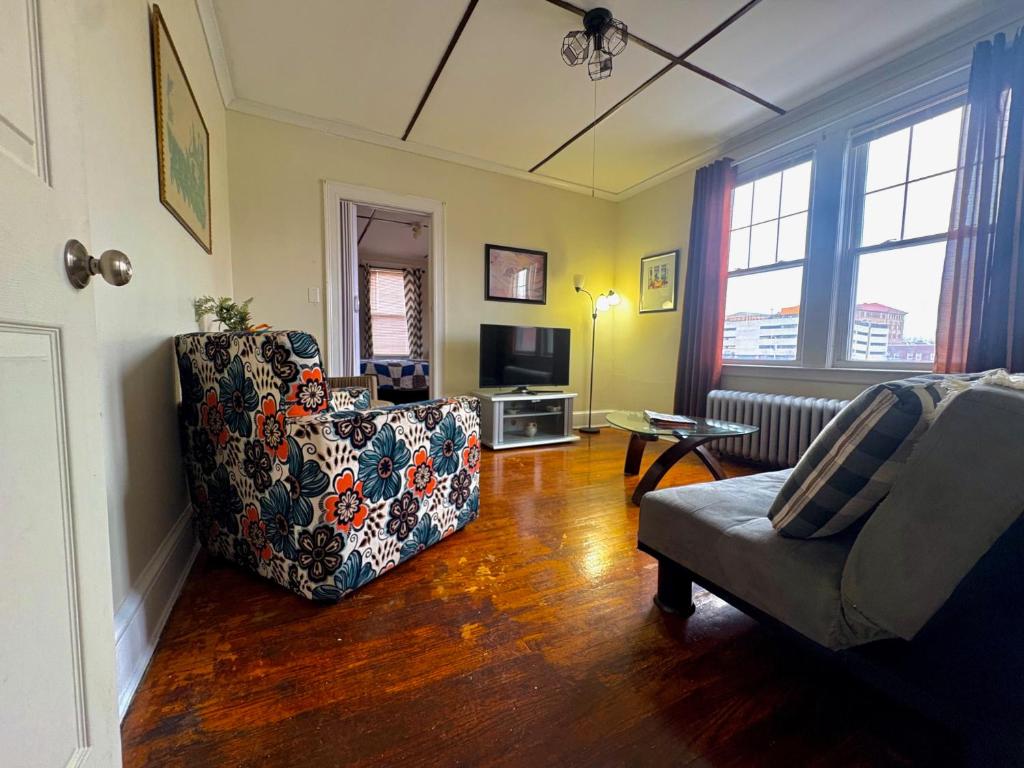 a living room with a couch and a chair at The Wadsworth Suite A2 in Hartford