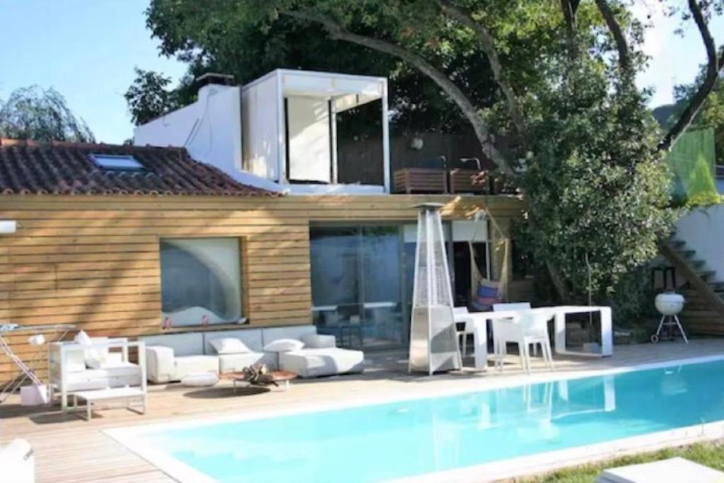 a villa with a swimming pool and a house at Casa da Granja in Sobral de Monte Agraço