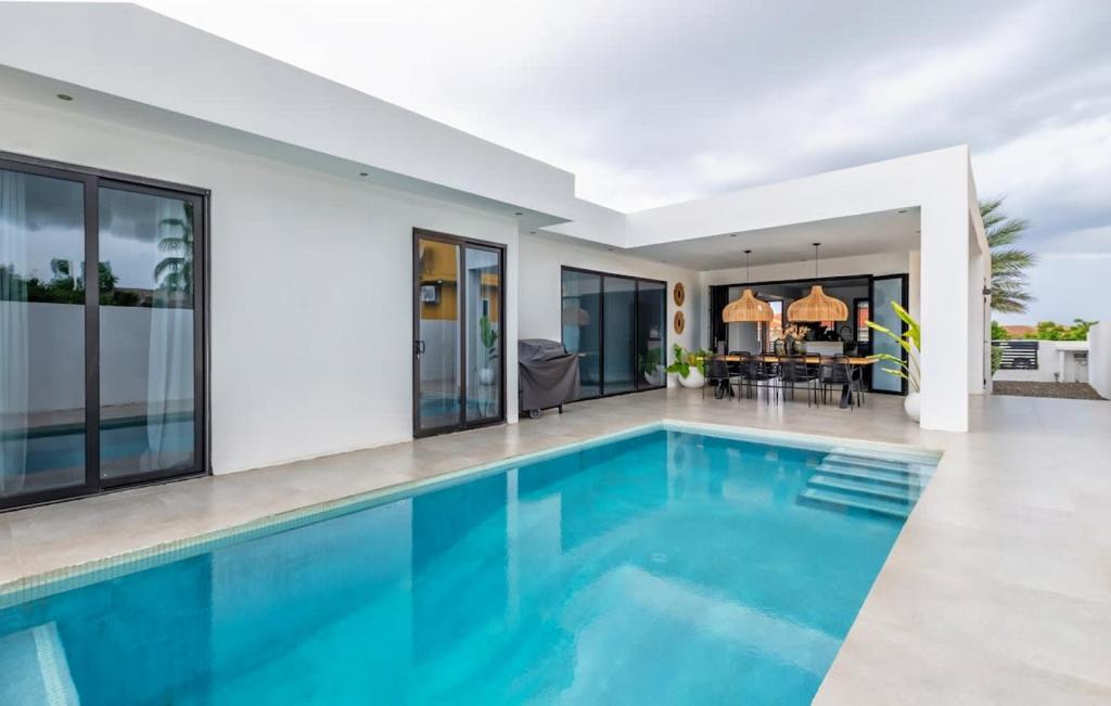 a swimming pool in a villa with a house at Casa Familia in Grote Berg