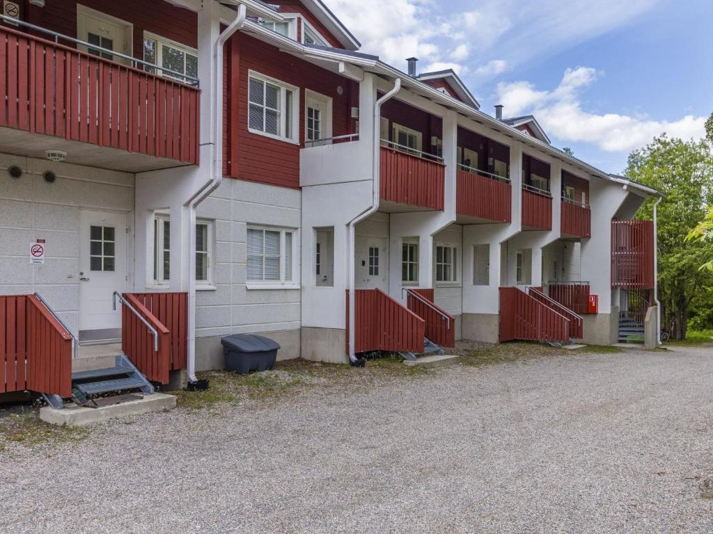 a row of apartment buildings with red fences at Holiday Home Levin mini by Interhome in Sirkka
