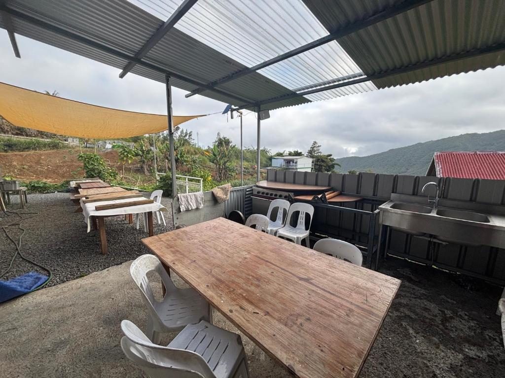 a patio with a table and a sink and a grill at Ti caze Montplaisir 2 in Saint-Louis