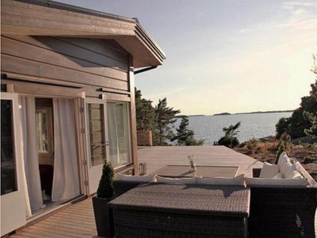 a house with a patio with a view of the water at Holiday Home Västantill by Interhome in Hitis