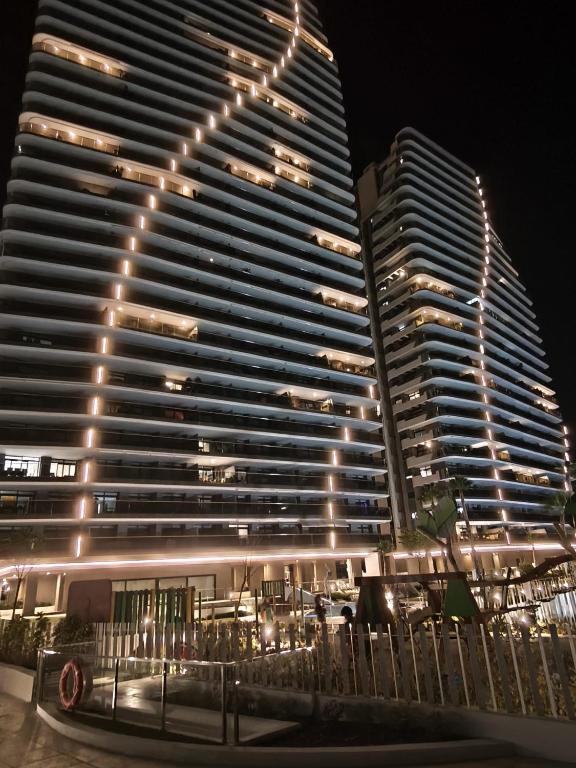 two tall buildings are lit up at night at Sunset Cliffs Luxury Apartment Benidorm in Benidorm