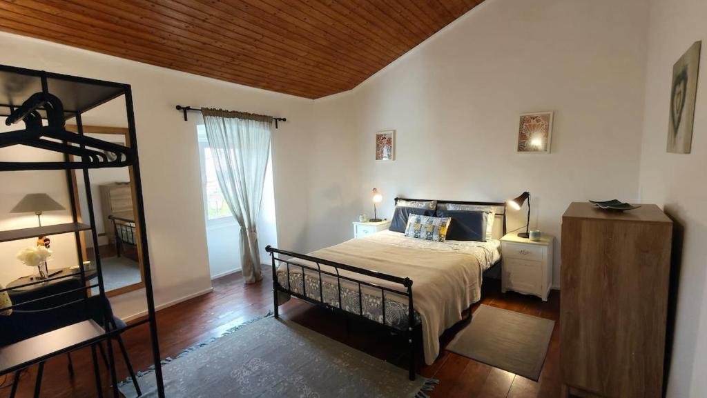 a bedroom with a bed and a mirror in it at Alentejo Colours Avis in Avis