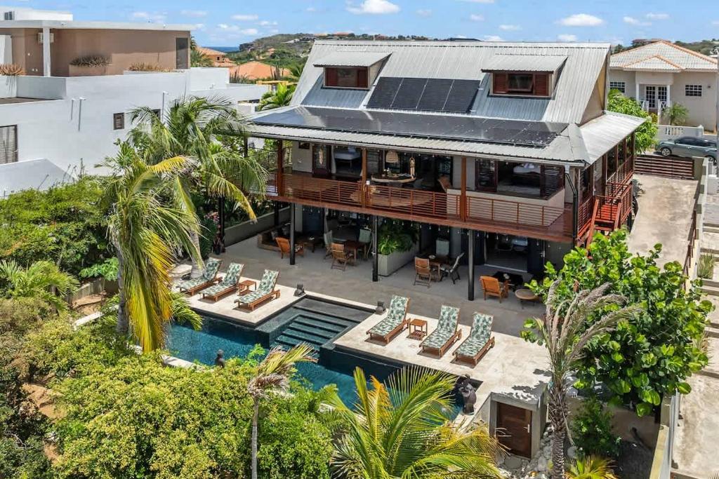 an aerial view of a house with solar panels on the roof at Bali Suites - Penthouse in Willemstad