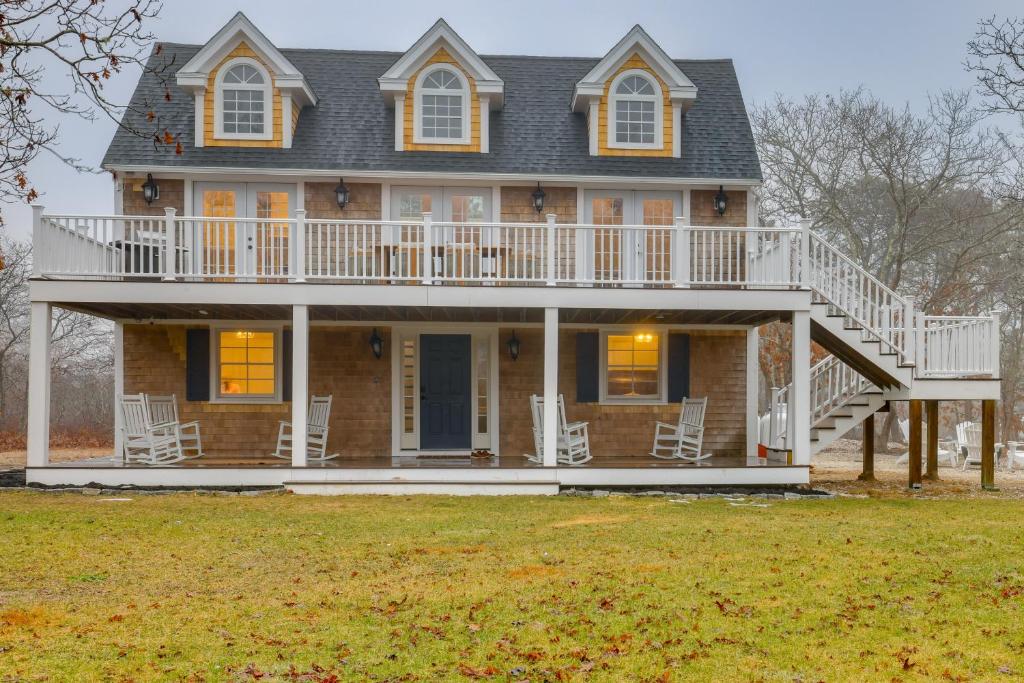 a large house with a wrap around porch and a deck at Summer Beach Pass: Wooded Martha's Vineyard Escape in Vineyard Haven