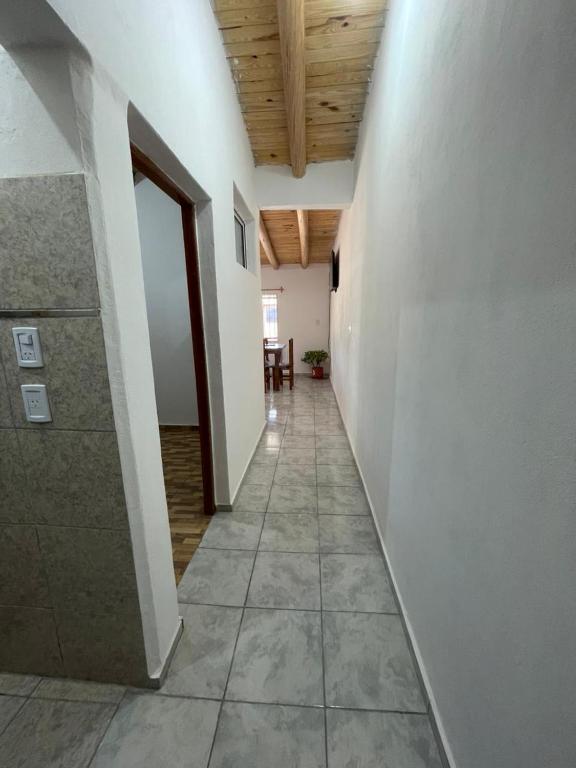 a hallway with white walls and a wooden ceiling at Brian Cuello in San Rafael