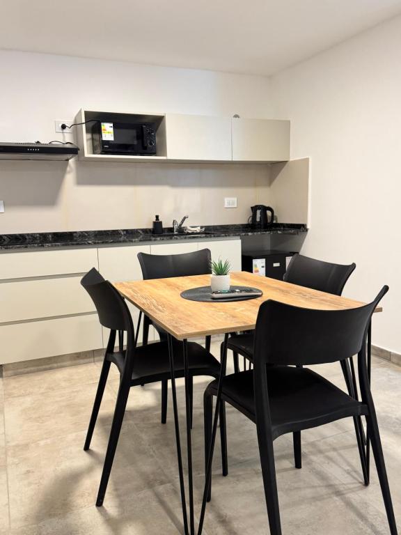 a wooden table and chairs in a kitchen at Vicente apart 2 - CON COCHERA in Villa María