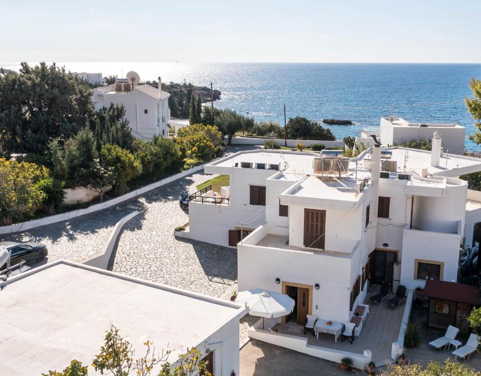 an aerial view of a white house and the ocean at Christine Beachside Villa Pefkos in Pefki