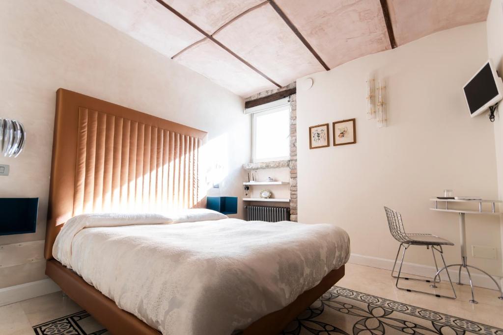a bedroom with a large bed and a chair at La suite del convento in Potenza