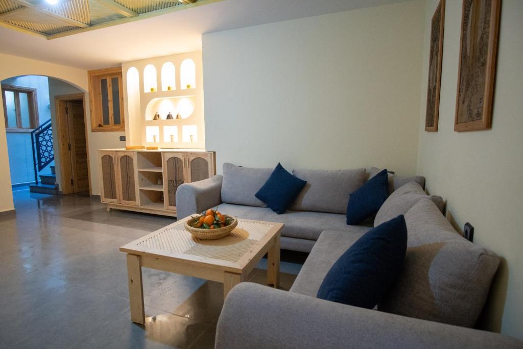a living room with a couch and a table at Surf House Desert Point in Agadir
