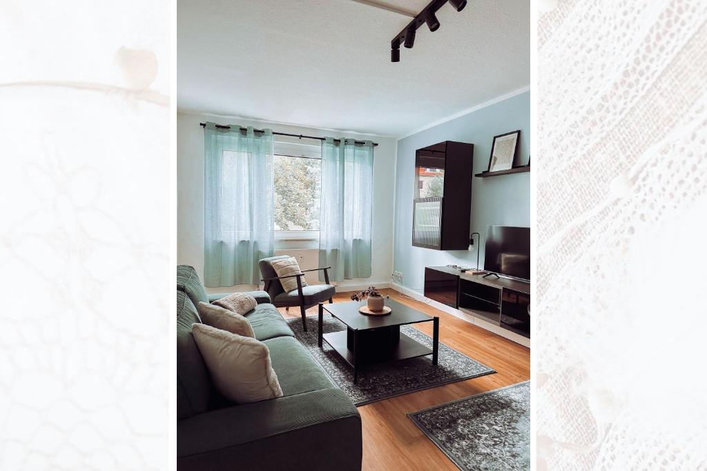 a living room with a couch and a table at Käferhain, App 135 in Groitzsch