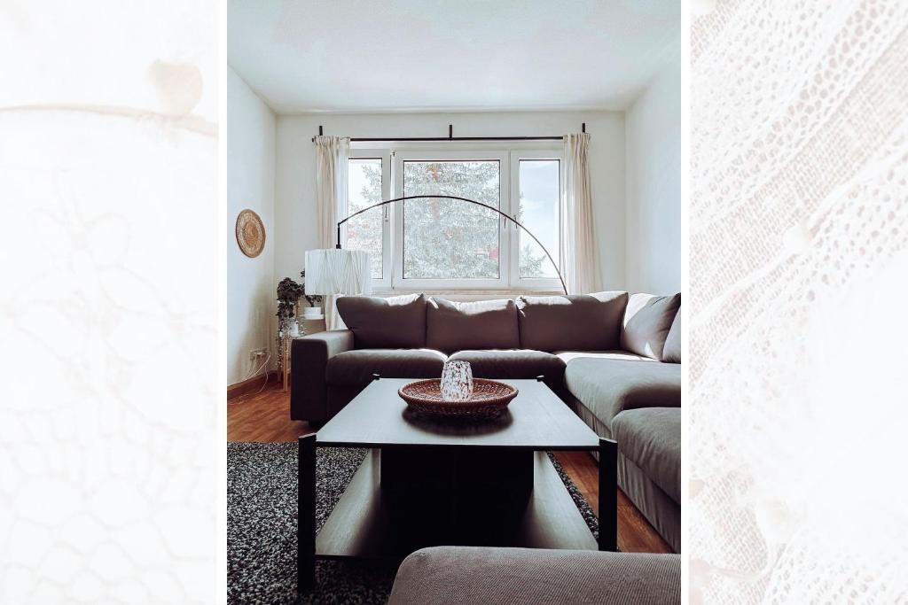 a living room with a couch and a table at Käferhain, App 134 in Groitzsch