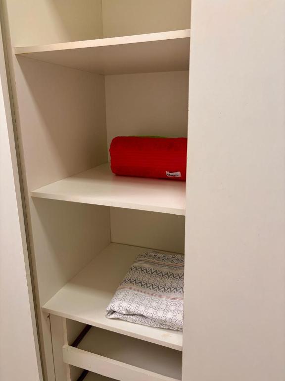 a small closet with a red bag on the shelf at Conta desativada in São Luís