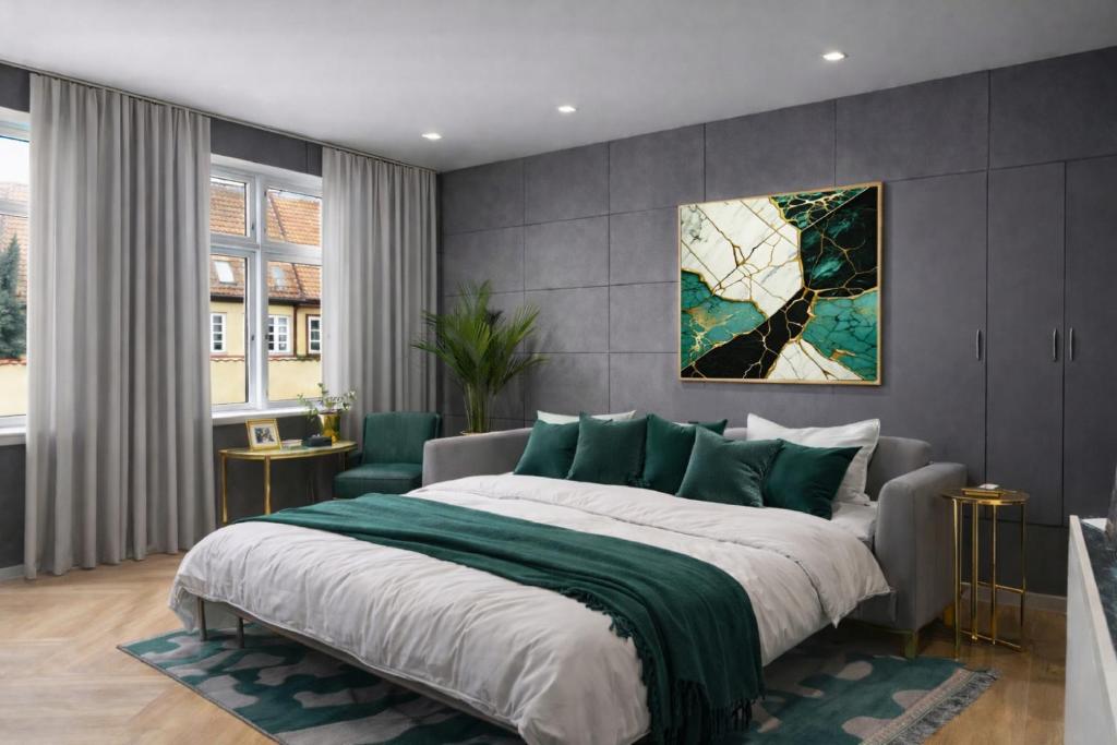 a bedroom with a large bed with a green blanket at 4SEASONS -- Emerald Summer Lounge in Aalborg